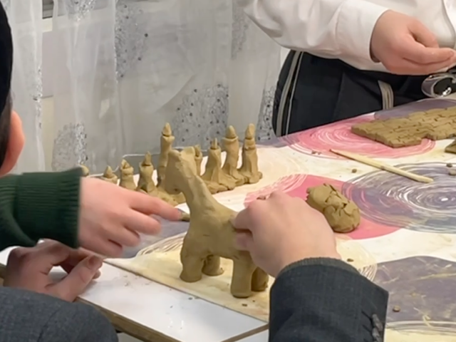 Children shaping clay figures