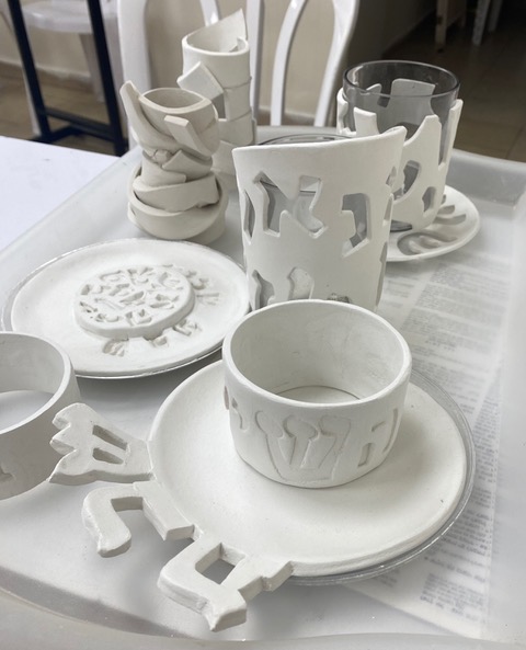 White ceramic pieces with Hebrew letters
