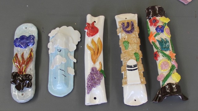 Five painted mezuzahs in a row