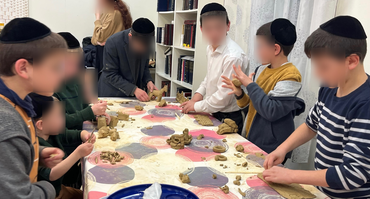 Teen students with clay sculptures