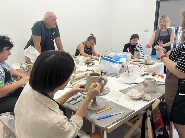 Student throwing on the pottery wheel