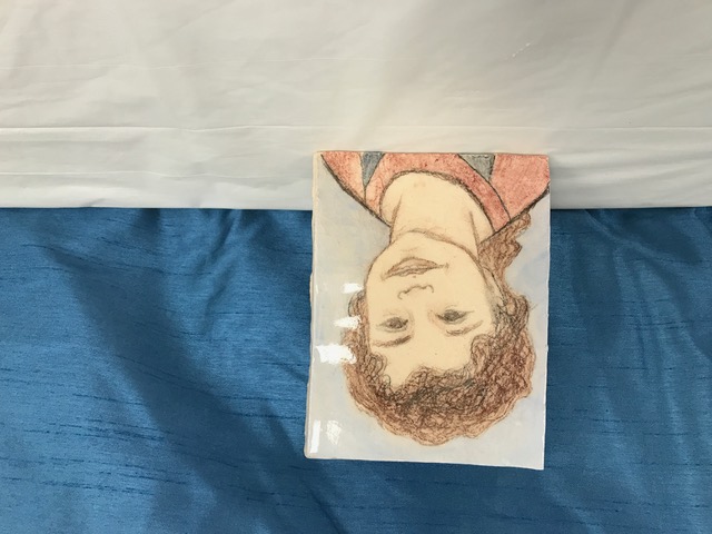 Student ceramic self-portrait tile