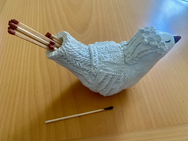 White ceramic bird match holder