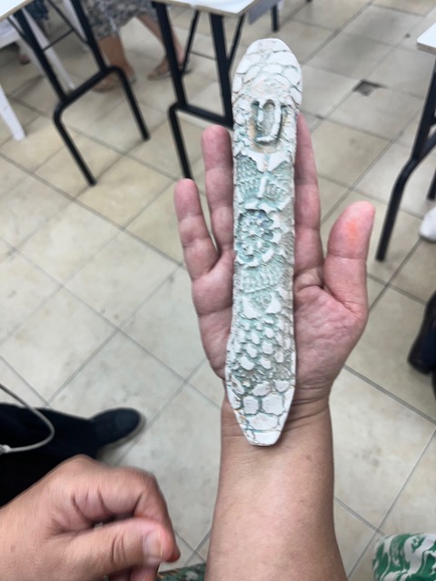 Long textured mezuzah in hand