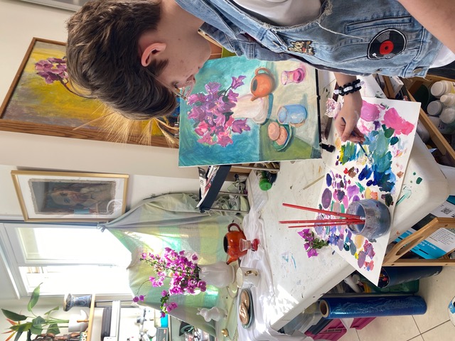 Student with floral paintings