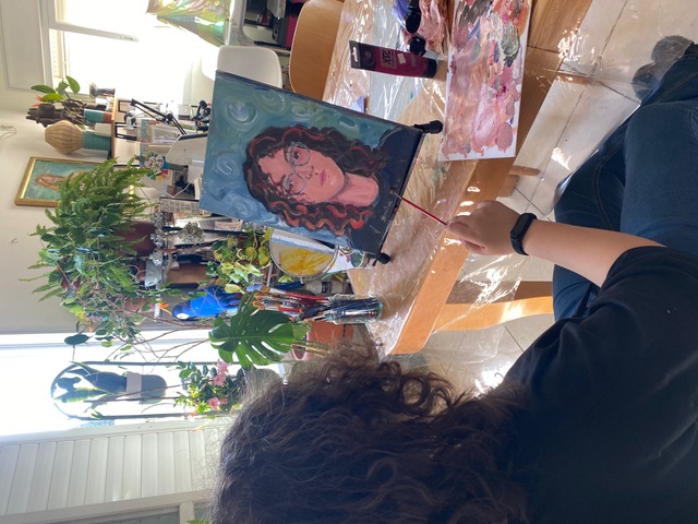 Student painting a self-portrait