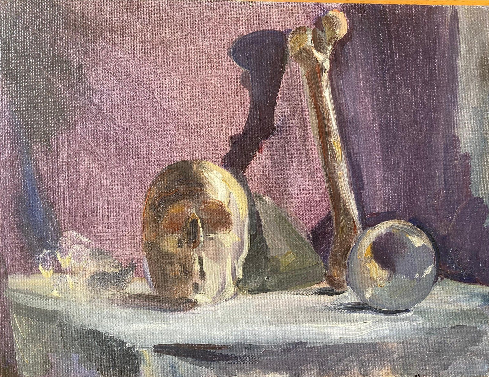 Oil still life with skull, bone, and glass sphere